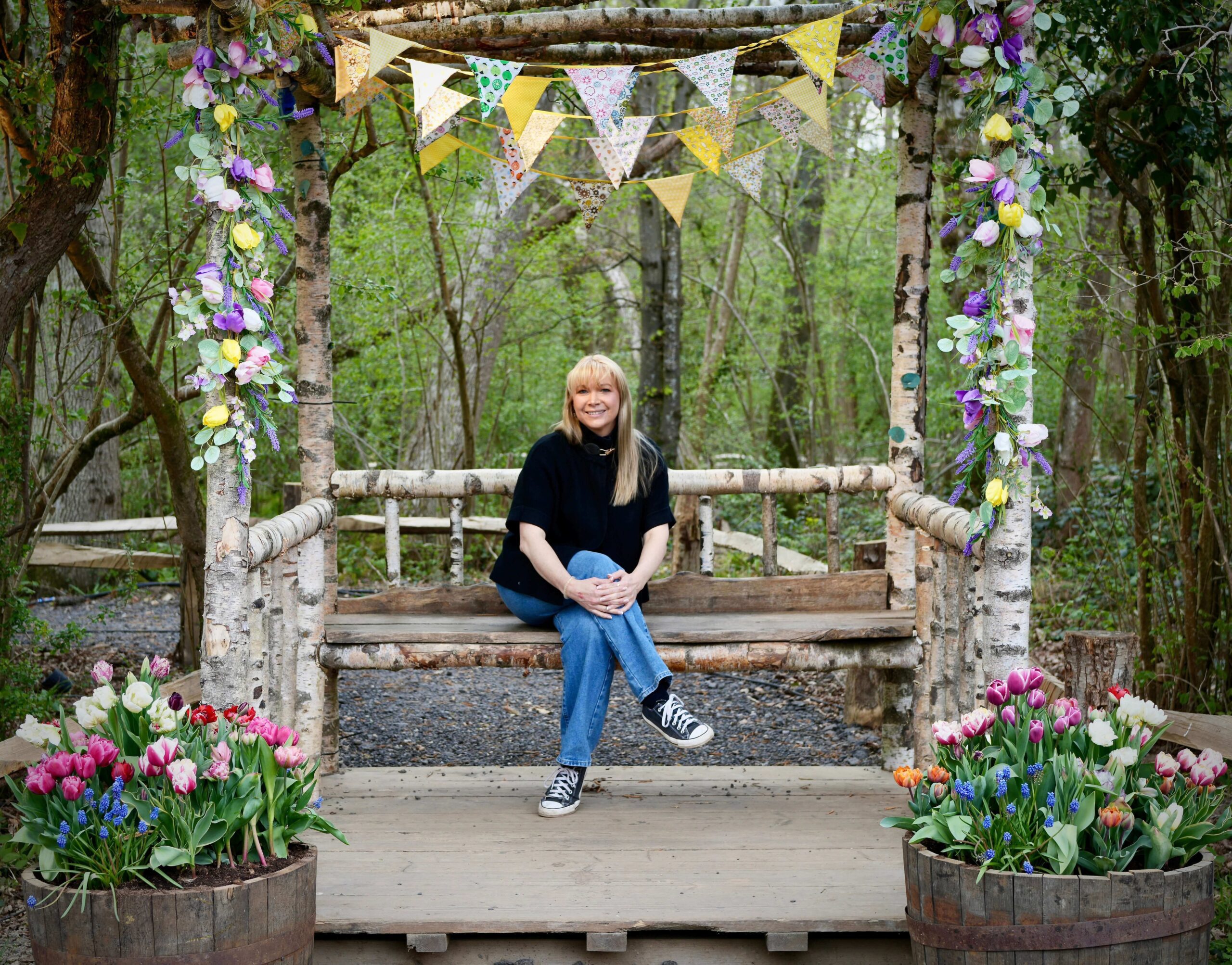  Becky Stone, ADHD therapist in Canterbury, sitting on a bench in a peaceful forest setting, offering walk and talk therapy for neurodivergent clients