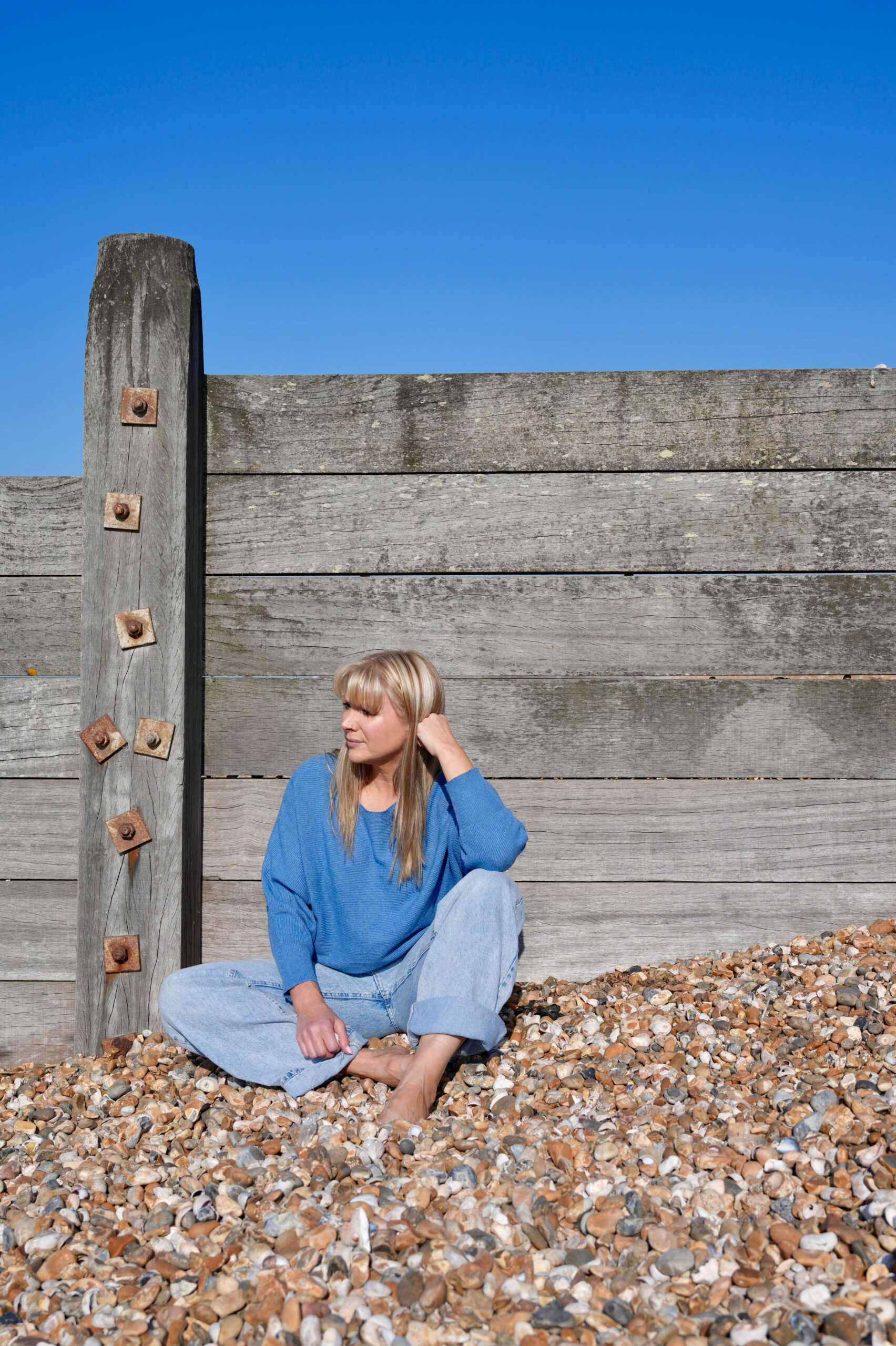 Teen girl sitting outside school steps looking anxious before walking in – school avoidance Canterbury support
