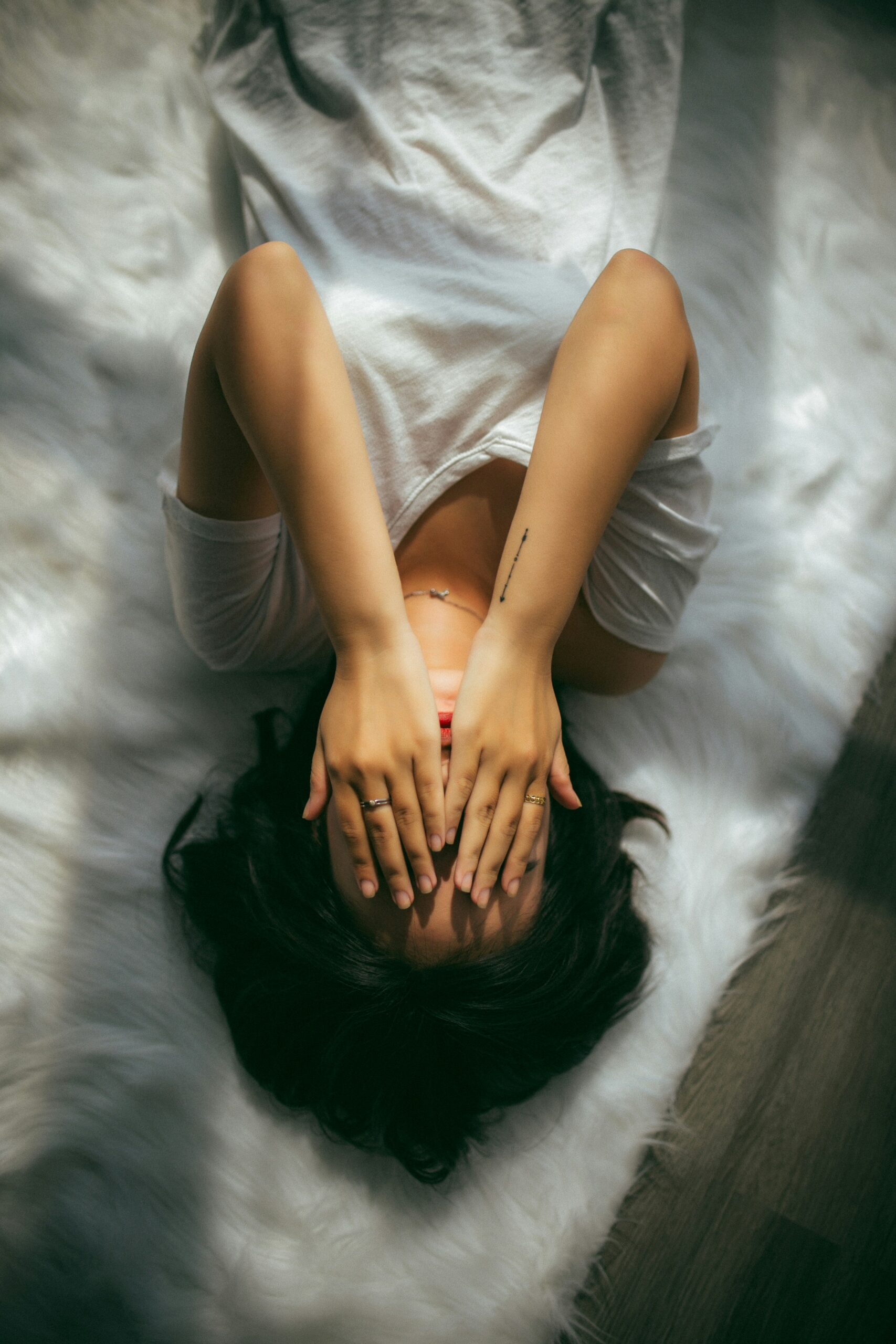 Person covering their face in water representing emotional overwhelm, confusion, and self-doubt linked to ADHD and gaslighting in relationships.