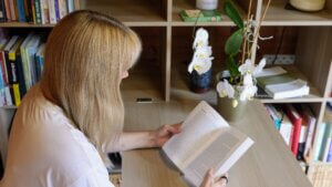 Becky Stone | Qualifications and Experience Becky Stone, binge eating disorder therapist reviewing client resources in her counselling practice
