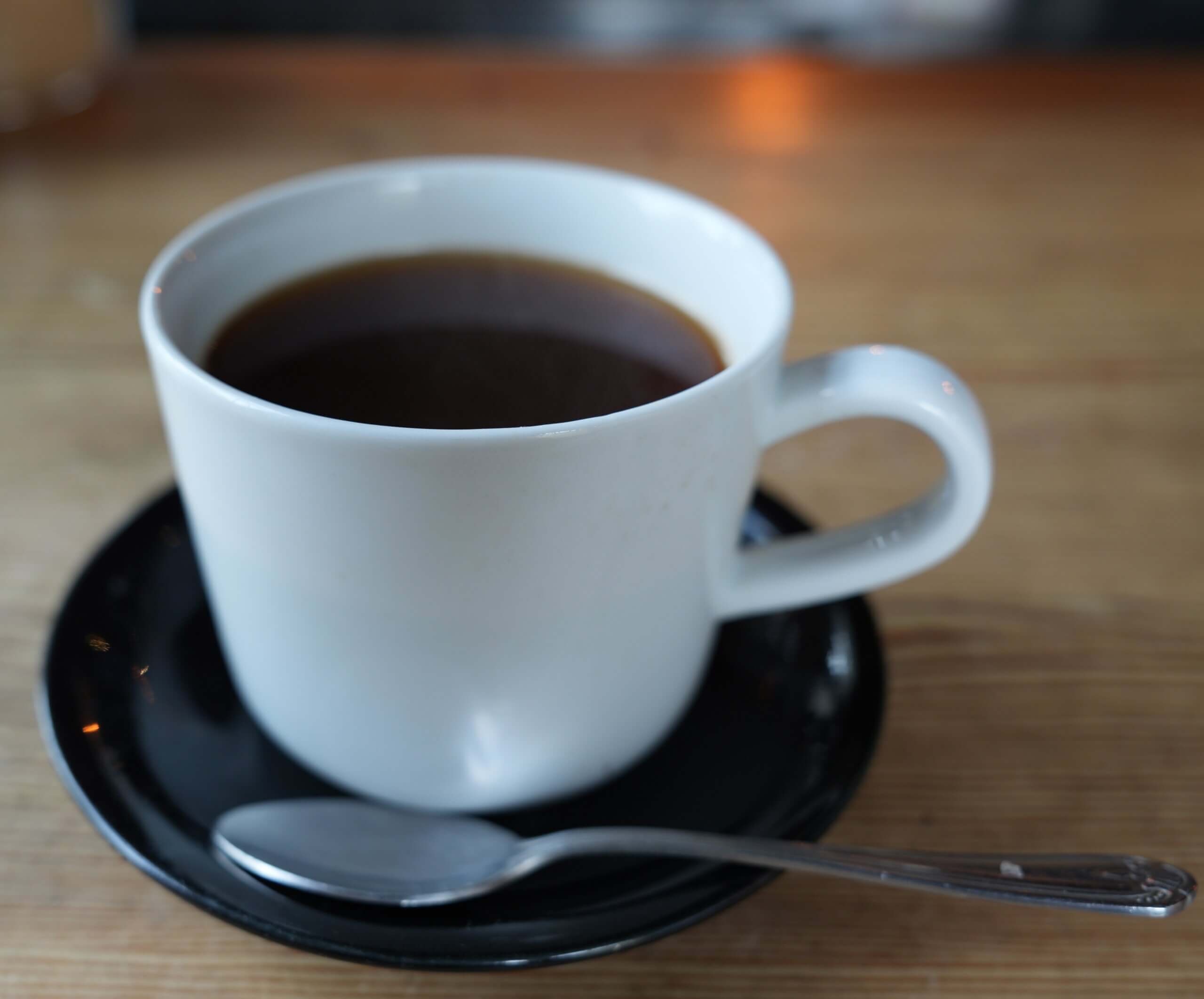 Cup of black coffee on a wooden table in a calm counselling setting